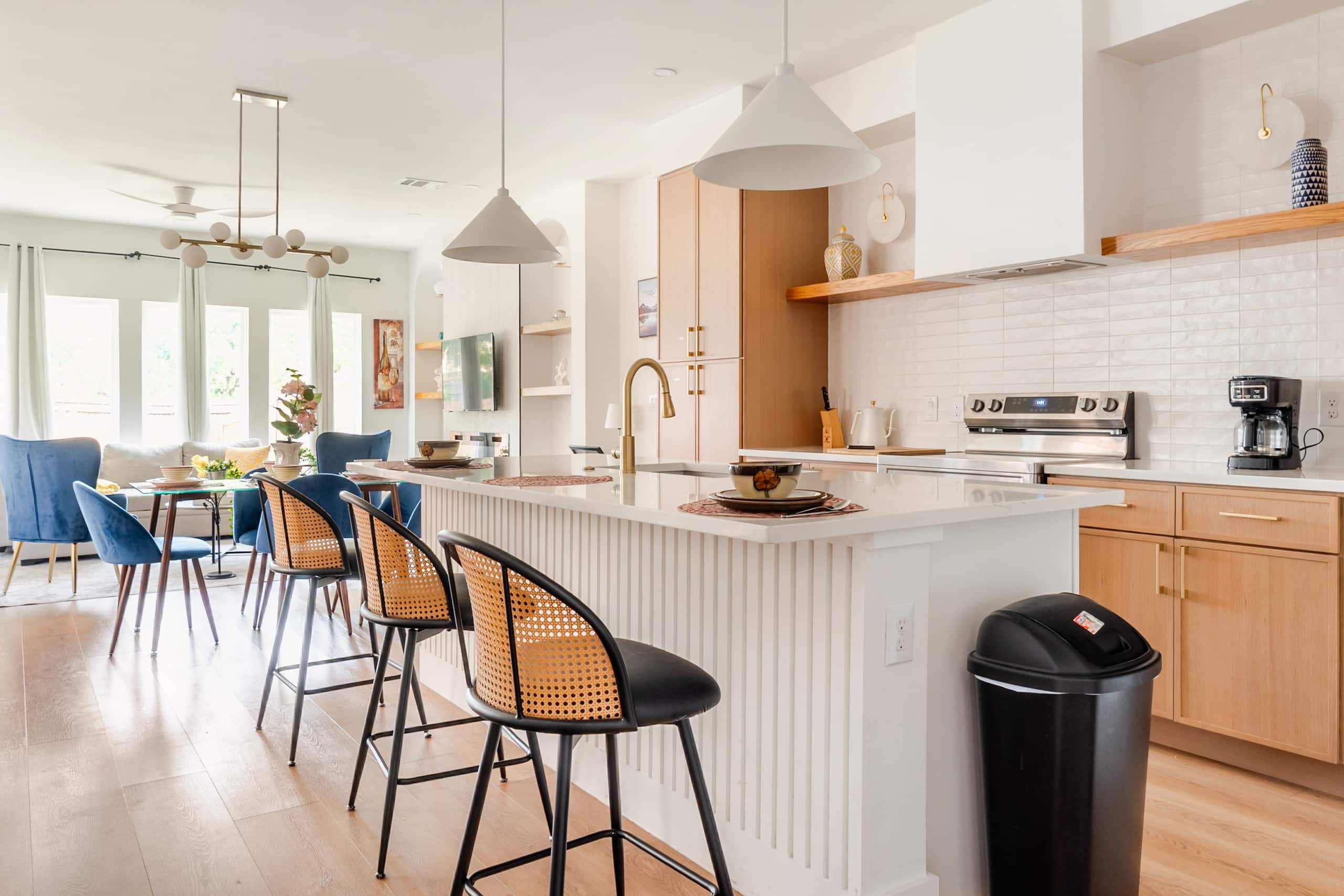 Modern open kitchen, island and dining area at Stay Fair Park, a vacation rental a 10-minute walk from Fair Park in Dallas
